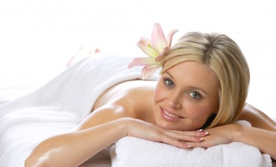 A woman relaxes after getting a massage at a day spa