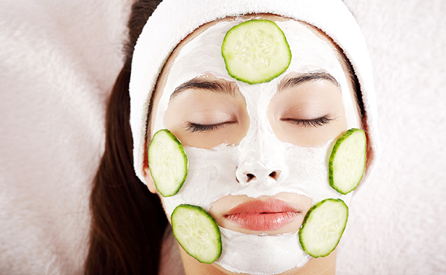 Woman with cucumber slices on the face