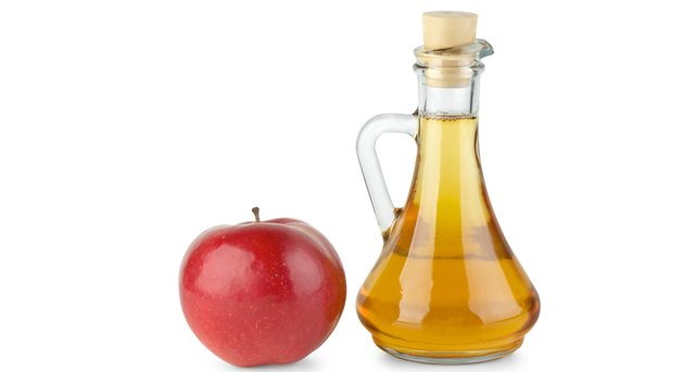 Decanter with apple vinegar and red apple